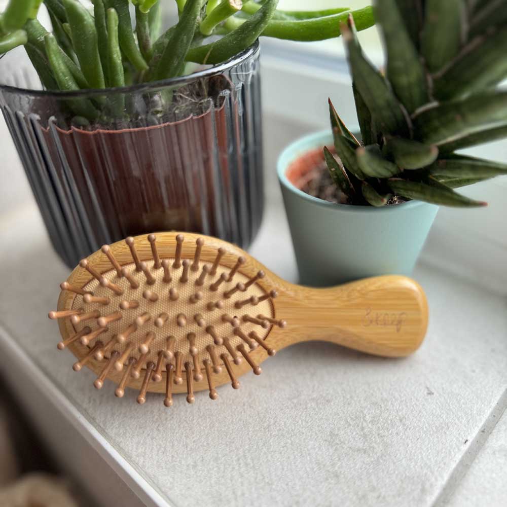 Mini bamboo hairbrush for travel plastic free eco friendly sustainable detangling